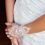 Boho white henna tattoos on arms and hands